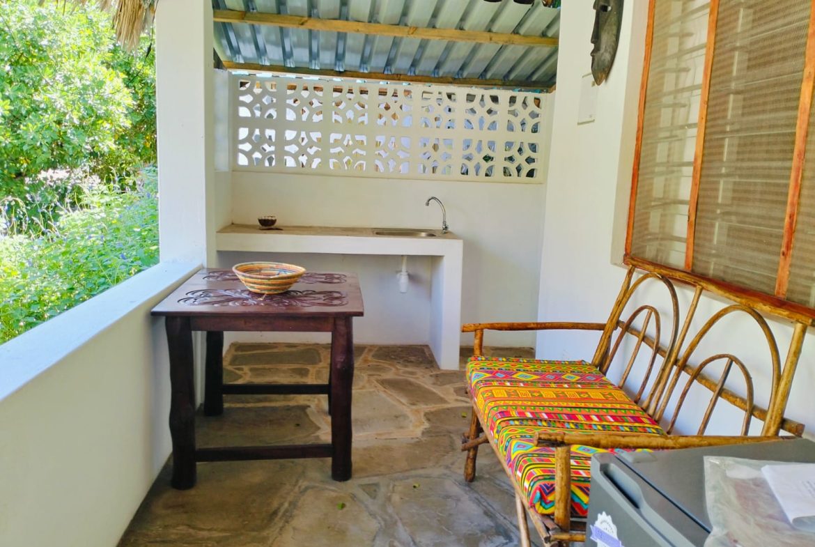 For sale: Three solar-powered bungalows in Watamu, just 15 minutes from the beach. Each en-suite one-bedroom chalet features stylish furnishings, a kitchenette, and shares a lush garden with a gazebo. Secure parking for three cars and priced at 13.5M ONO, offering excellent investment potential.