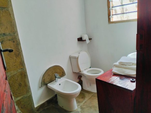 For sale: Three solar-powered bungalows in Watamu, just 15 minutes from the beach. Each en-suite one-bedroom chalet features stylish furnishings, a kitchenette, and shares a lush garden with a gazebo. Secure parking for three cars and priced at 13.5M ONO, offering excellent investment potential.