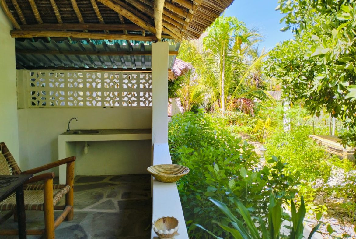 For sale: Three solar-powered bungalows in Watamu, just 15 minutes from the beach. Each en-suite one-bedroom chalet features stylish furnishings, a kitchenette, and shares a lush garden with a gazebo. Secure parking for three cars and priced at 13.5M ONO, offering excellent investment potential.