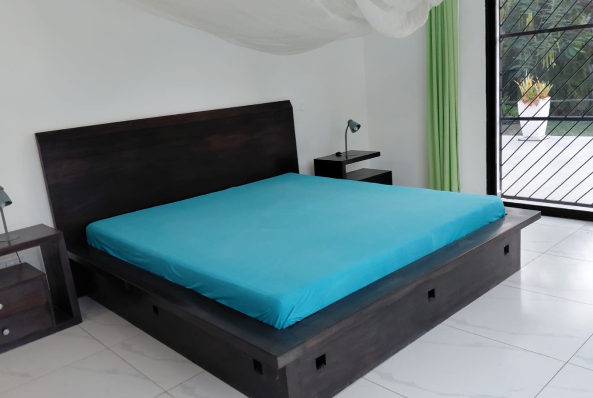 Luxury U-Shaped 4-Bedroom Home in Watamu | ½ Acre, Infinity Pool, 5-Car Garage & Private Garden – KES 42M
