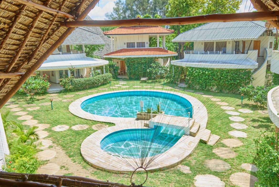 Fully furnished 2-bedroom duplex cottage for sale at Park Marine Villas, Silversands Road Malindi. Each floor has a bedroom. Steps to beach, 2 pools. €125,000.