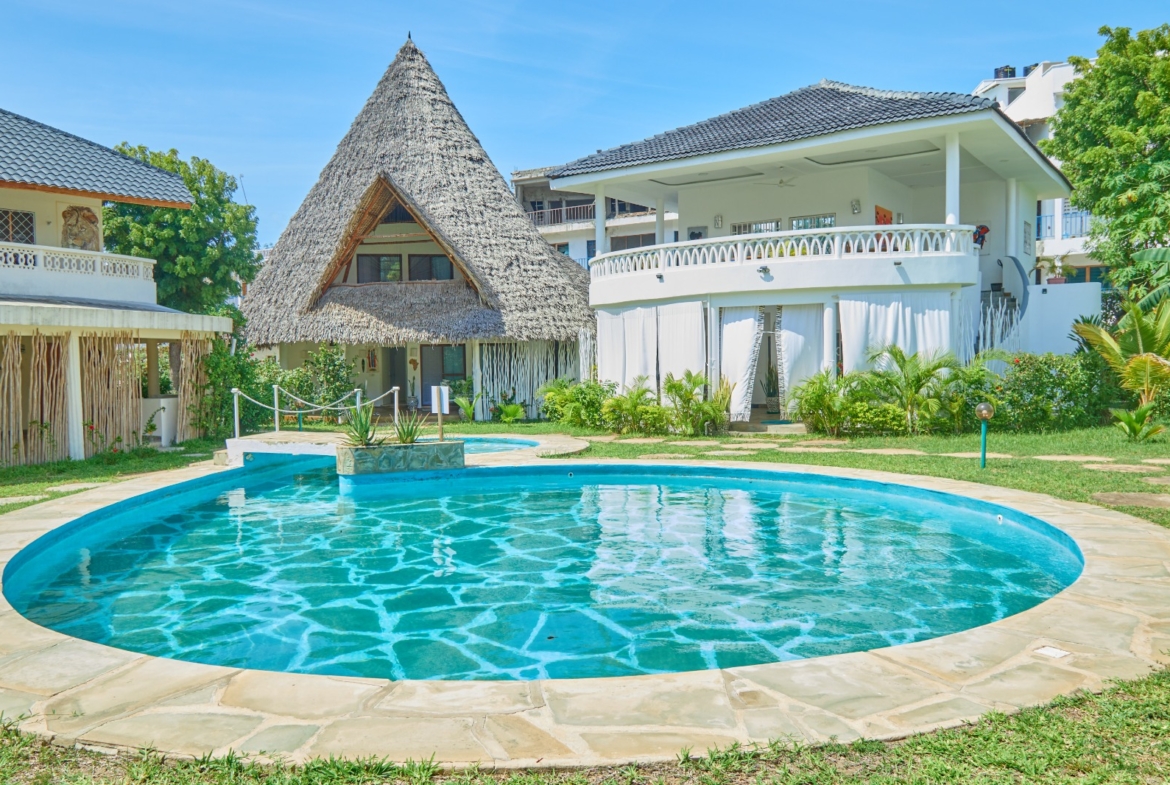Fully furnished 2-bedroom duplex cottage for sale at Park Marine Villas, Silversands Road Malindi. Each floor has a bedroom. Steps to beach, 2 pools. €125,000.