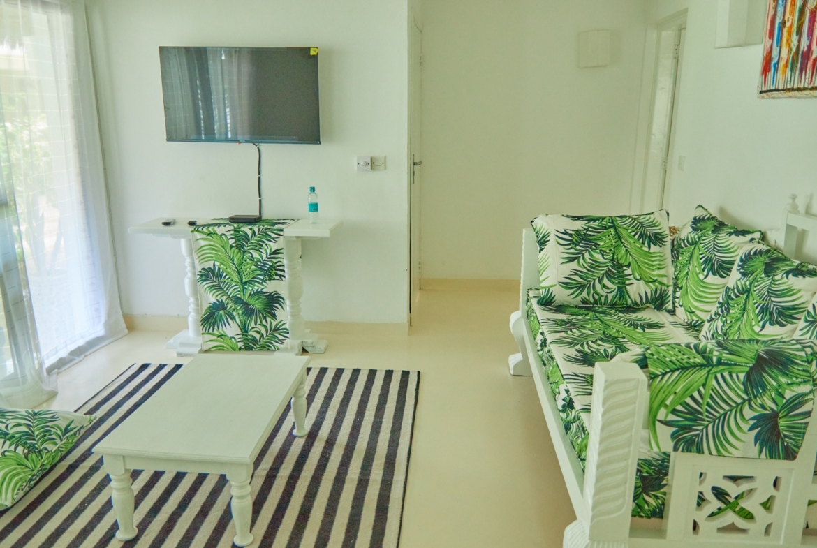 Fully furnished 2-bedroom duplex cottage for sale at Park Marine Villas, Silversands Road Malindi. Each floor has a bedroom. Steps to beach, 2 pools. €125,000.
