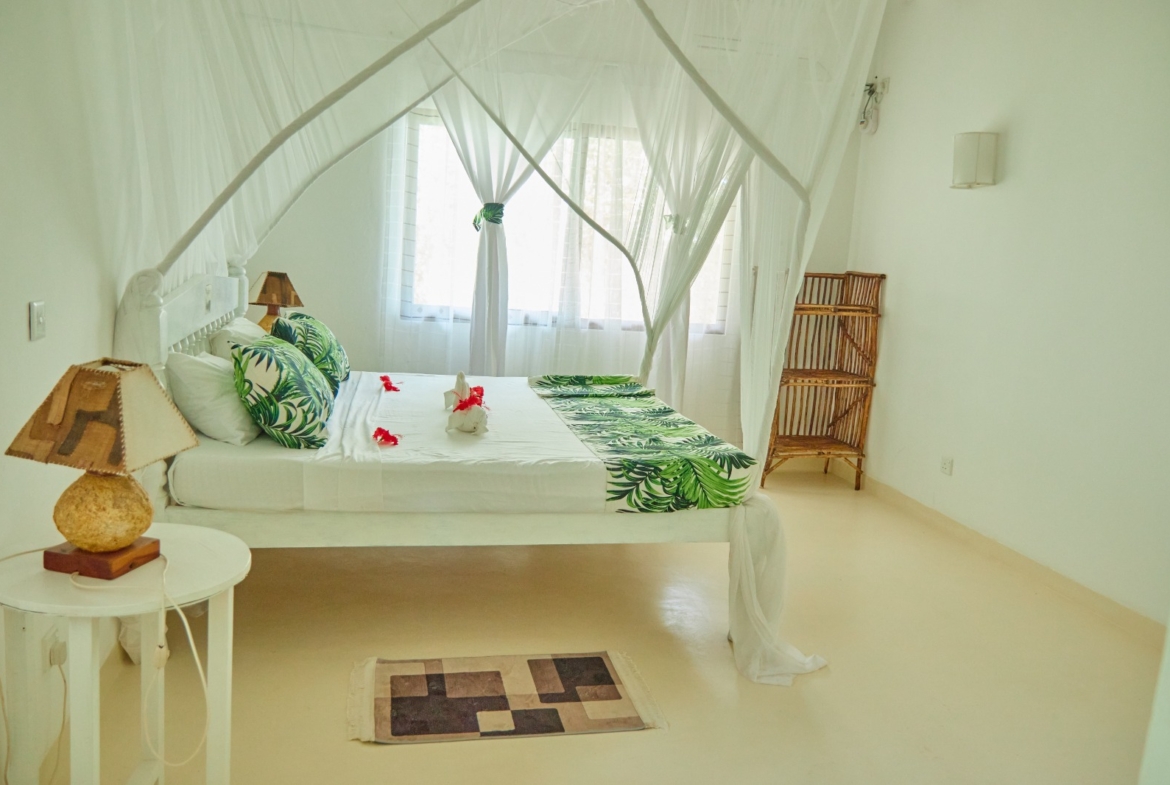 Fully furnished 2-bedroom duplex cottage for sale at Park Marine Villas, Silversands Road Malindi. Each floor has a bedroom. Steps to beach, 2 pools. €125,000.