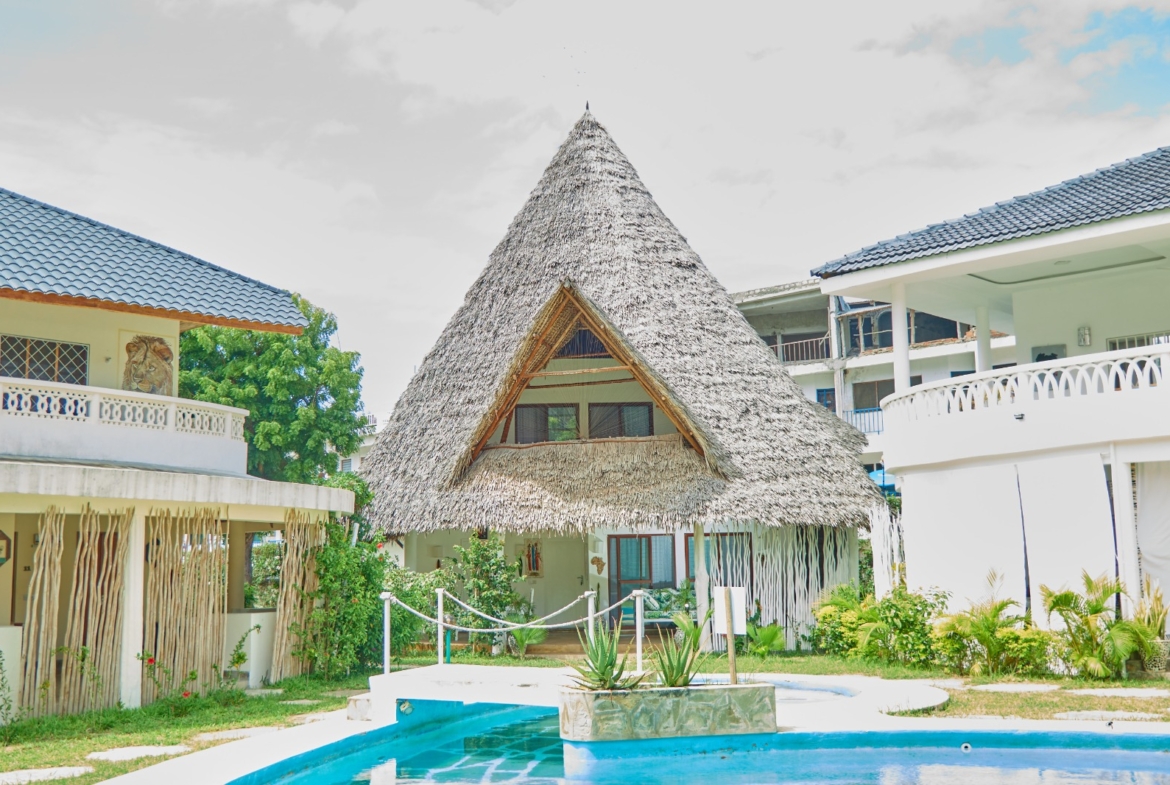 Fully furnished 2-bedroom duplex cottage for sale at Park Marine Villas, Silversands Road Malindi. Each floor has a bedroom. Steps to beach, 2 pools. €125,000.