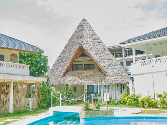 Fully furnished 2-bedroom duplex cottage for sale at Park Marine Villas, Silversands Road Malindi. Each floor has a bedroom. Steps to beach, 2 pools. €125,000.