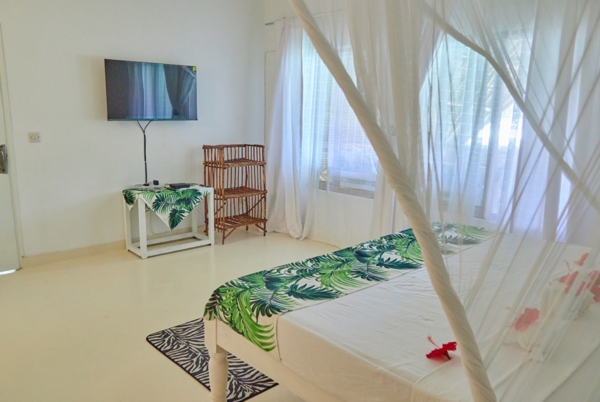Fully furnished 2-bedroom duplex cottage for sale at Park Marine Villas, Silversands Road Malindi. Each floor has a bedroom. Steps to beach, 2 pools. €125,000.