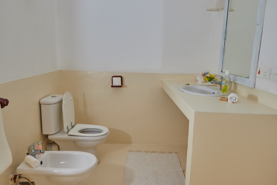 Fully furnished 2-bedroom duplex cottage for sale at Park Marine Villas, Silversands Road Malindi. Each floor has a bedroom. Steps to beach, 2 pools. €125,000.