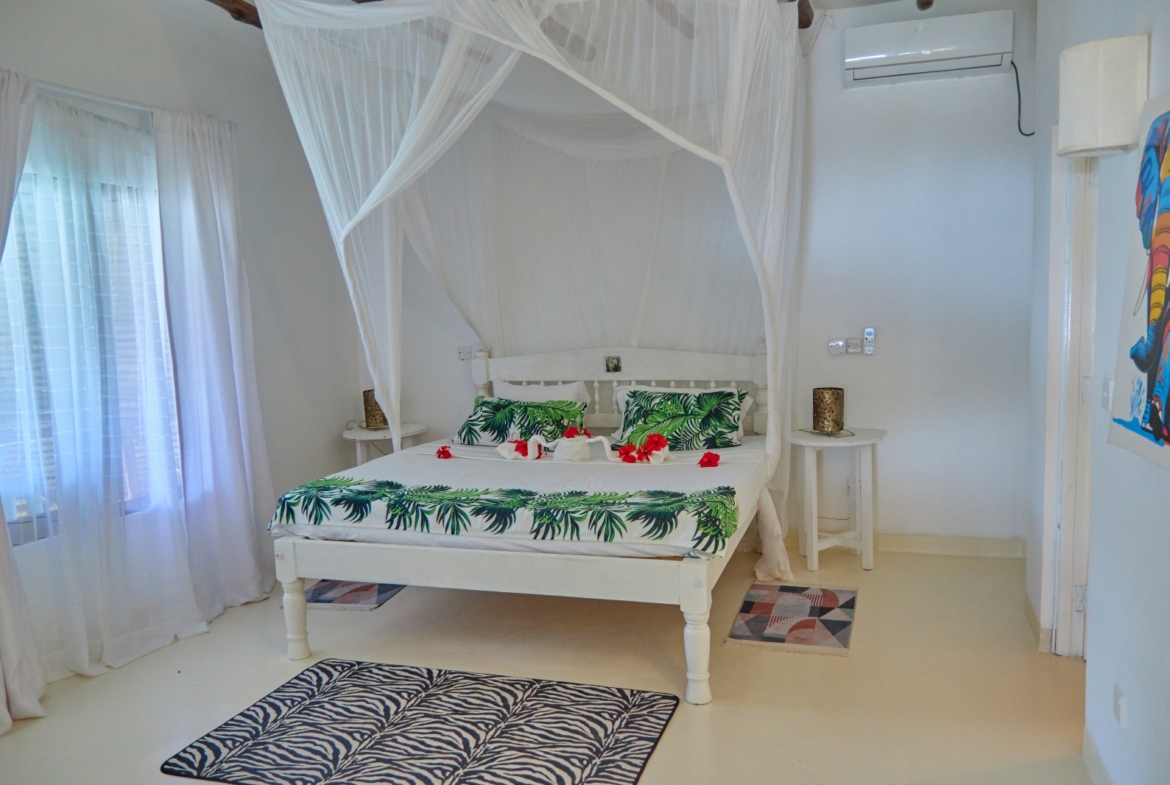 Fully furnished 2-bedroom duplex cottage for sale at Park Marine Villas, Silversands Road Malindi. Each floor has a bedroom. Steps to beach, 2 pools. €125,000.