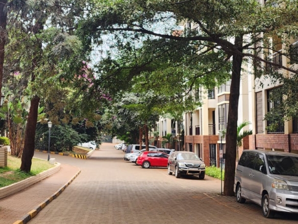 “Spacious living room at Jacaranda Gardens Apartments with natural lighting and balcony”