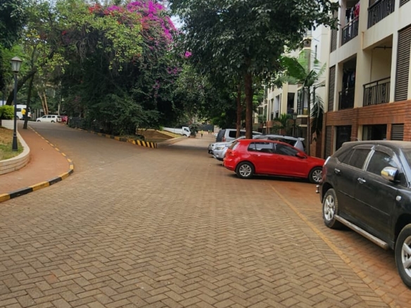 “Spacious living room at Jacaranda Gardens Apartments with natural lighting and balcony”