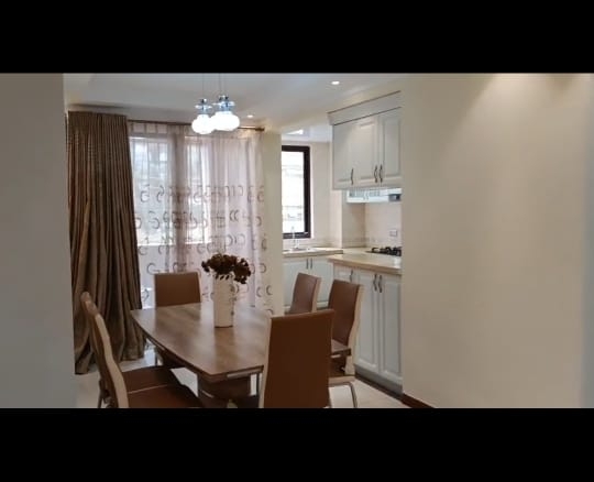 “Spacious living room at Jacaranda Gardens Apartments with natural lighting and balcony”