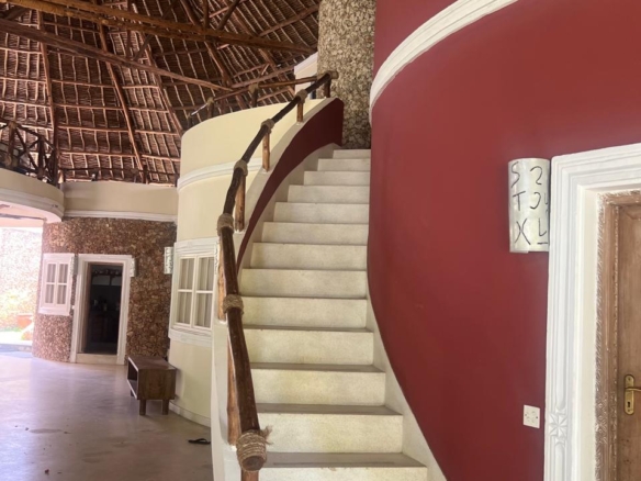 Prime 4-bedroom coastal home for sale in Kibokoni with a 2-bedroom guest suite earning USD 100 per night. Nearly half-acre plot, ideal for investors and families.