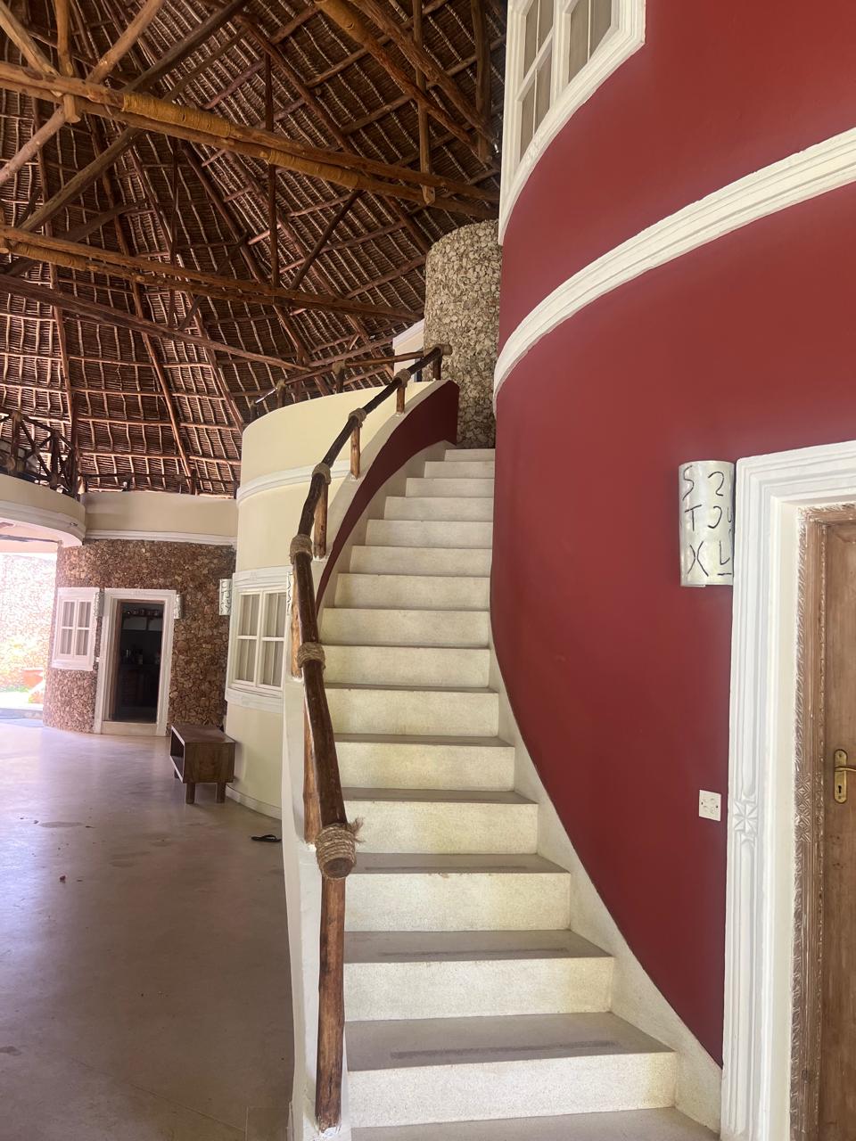 Prime 4-bedroom coastal home for sale in Kibokoni with a 2-bedroom guest suite earning USD 100 per night. Nearly half-acre plot, ideal for investors and families.