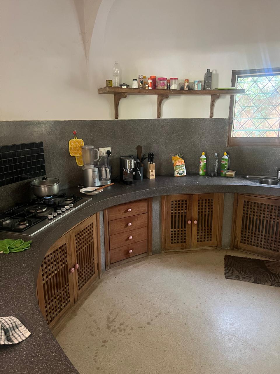 Prime 4-bedroom coastal home for sale in Kibokoni with a 2-bedroom guest suite earning USD 100 per night. Nearly half-acre plot, ideal for investors and families.