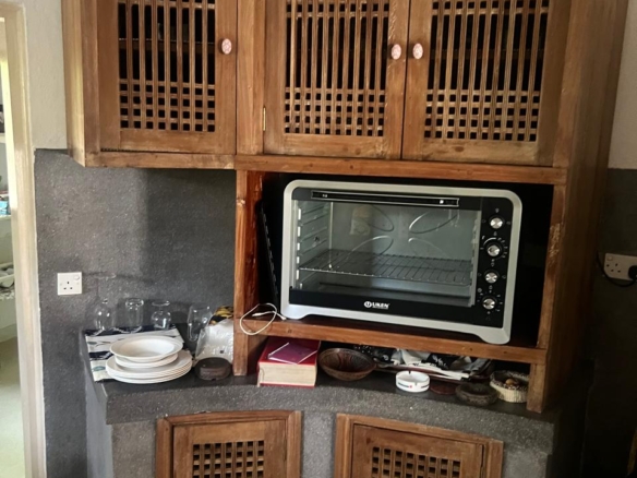 Prime 4-bedroom coastal home for sale in Kibokoni with a 2-bedroom guest suite earning USD 100 per night. Nearly half-acre plot, ideal for investors and families.