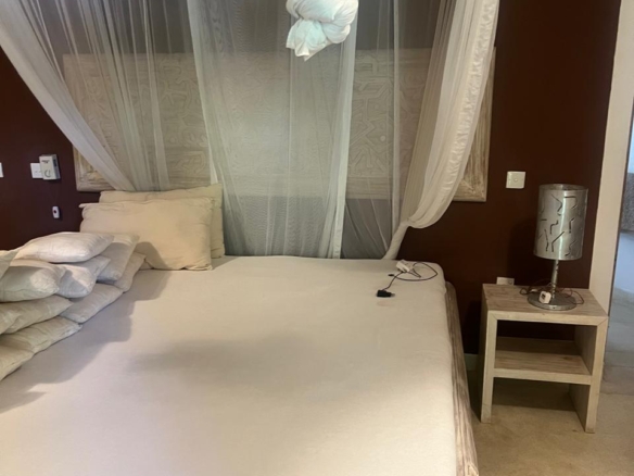 Prime 4-bedroom coastal home for sale in Kibokoni with a 2-bedroom guest suite earning USD 100 per night. Nearly half-acre plot, ideal for investors and families.