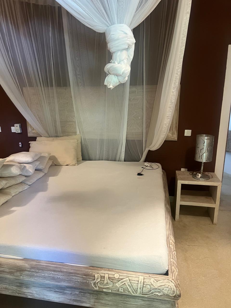 Prime 4-bedroom coastal home for sale in Kibokoni with a 2-bedroom guest suite earning USD 100 per night. Nearly half-acre plot, ideal for investors and families.