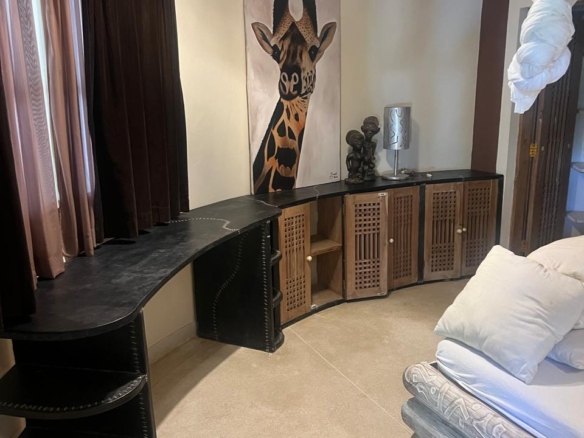 Prime 4-bedroom coastal home for sale in Kibokoni with a 2-bedroom guest suite earning USD 100 per night. Nearly half-acre plot, ideal for investors and families.