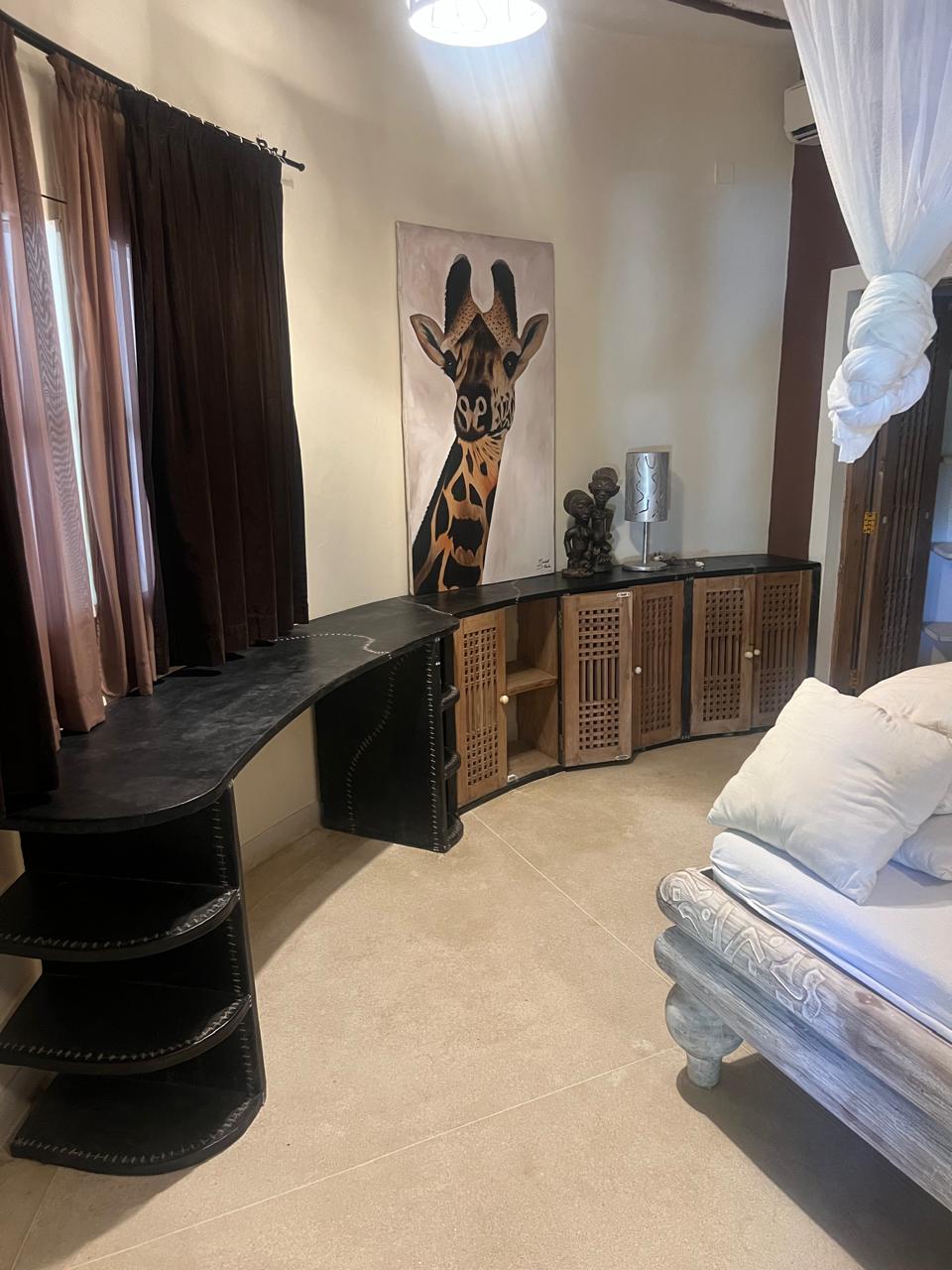 Prime 4-bedroom coastal home for sale in Kibokoni with a 2-bedroom guest suite earning USD 100 per night. Nearly half-acre plot, ideal for investors and families.