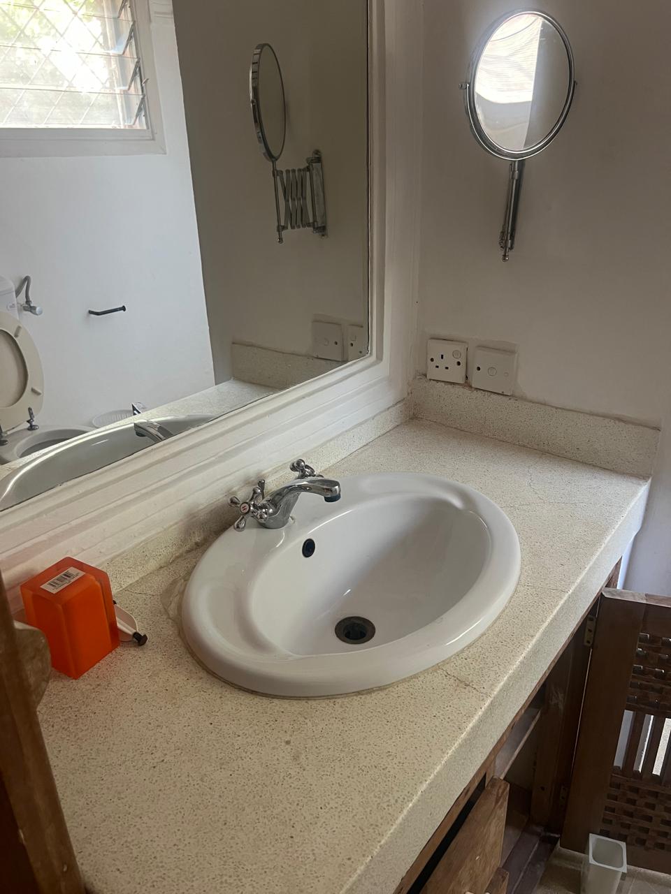 Prime 4-bedroom coastal home for sale in Kibokoni with a 2-bedroom guest suite earning USD 100 per night. Nearly half-acre plot, ideal for investors and families.