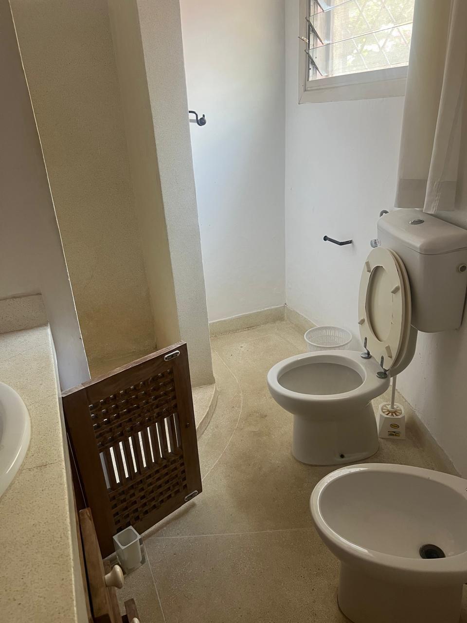 Prime 4-bedroom coastal home for sale in Kibokoni with a 2-bedroom guest suite earning USD 100 per night. Nearly half-acre plot, ideal for investors and families.