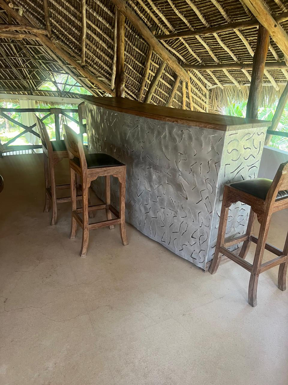 Prime 4-bedroom coastal home for sale in Kibokoni with a 2-bedroom guest suite earning USD 100 per night. Nearly half-acre plot, ideal for investors and families.