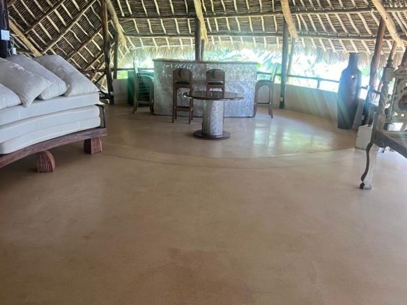 Prime 4-bedroom coastal home for sale in Kibokoni with a 2-bedroom guest suite earning USD 100 per night. Nearly half-acre plot, ideal for investors and families.