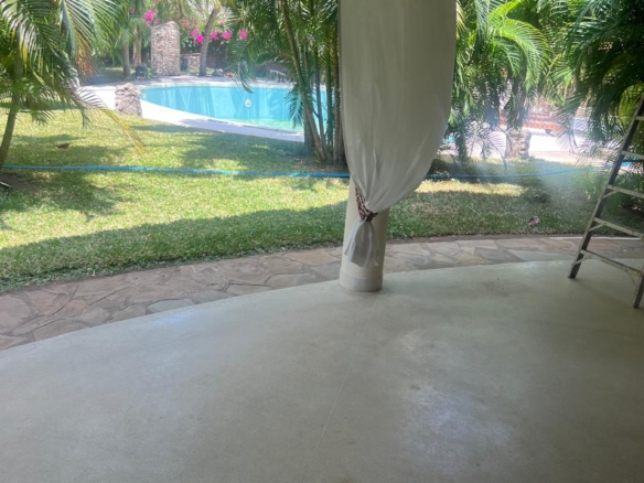 Prime 4-bedroom coastal home for sale in Kibokoni with a 2-bedroom guest suite earning USD 100 per night. Nearly half-acre plot, ideal for investors and families.