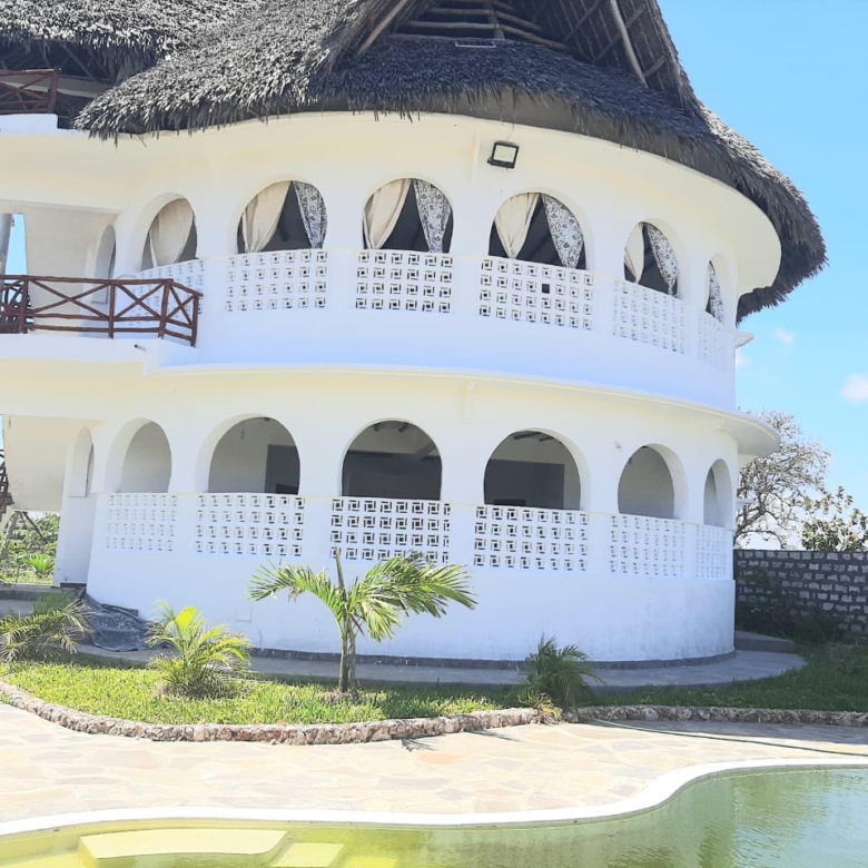 Luxury 2-bedroom guest suite in Mayungu, Malindi featuring ocean views, ensuite rooms, shared kitchen, furnished patio, tropical gardens, and a pristine swimming pool. Perfect self-catering coastal accommodation for only USD 100 per night.