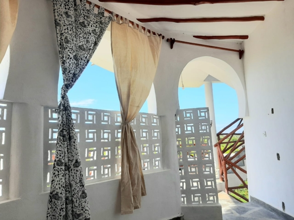 Luxury 2-bedroom guest suite in Mayungu, Malindi featuring ocean views, ensuite rooms, shared kitchen, furnished patio, tropical gardens, and a pristine swimming pool. Perfect self-catering coastal accommodation for only USD 100 per night.