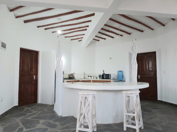 Luxury 2-bedroom guest suite in Mayungu, Malindi featuring ocean views, ensuite rooms, shared kitchen, furnished patio, tropical gardens, and a pristine swimming pool. Perfect self-catering coastal accommodation for only USD 100 per night.