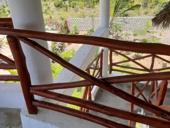 Luxury 2-bedroom guest suite in Mayungu, Malindi featuring ocean views, ensuite rooms, shared kitchen, furnished patio, tropical gardens, and a pristine swimming pool. Perfect self-catering coastal accommodation for only USD 100 per night.