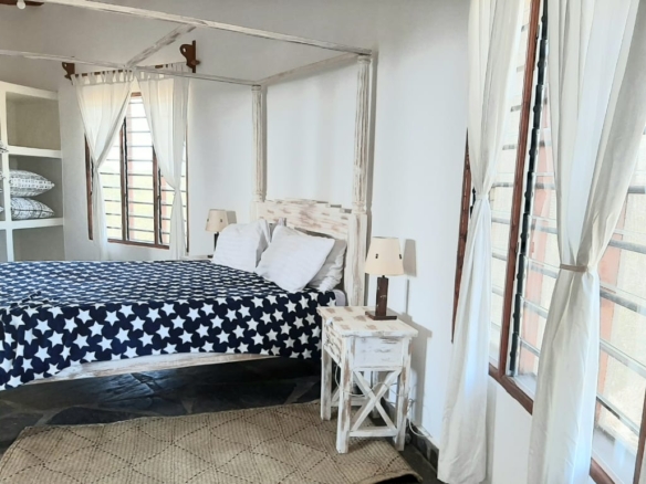 Luxury 2-bedroom guest suite in Mayungu, Malindi featuring ocean views, ensuite rooms, shared kitchen, furnished patio, tropical gardens, and a pristine swimming pool. Perfect self-catering coastal accommodation for only USD 100 per night.