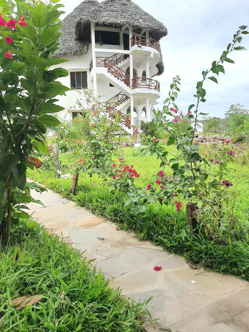 Luxury 2-bedroom guest suite in Mayungu, Malindi featuring ocean views, ensuite rooms, shared kitchen, furnished patio, tropical gardens, and a pristine swimming pool. Perfect self-catering coastal accommodation for only USD 100 per night.