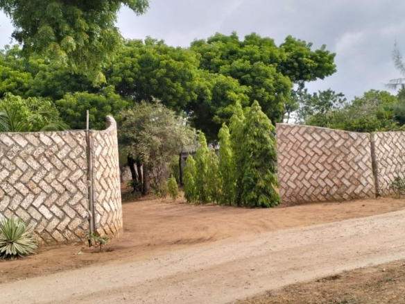 One-acre freehold plots for sale in Kizingo, watamu with red soil, flat land, and on-site utilities.