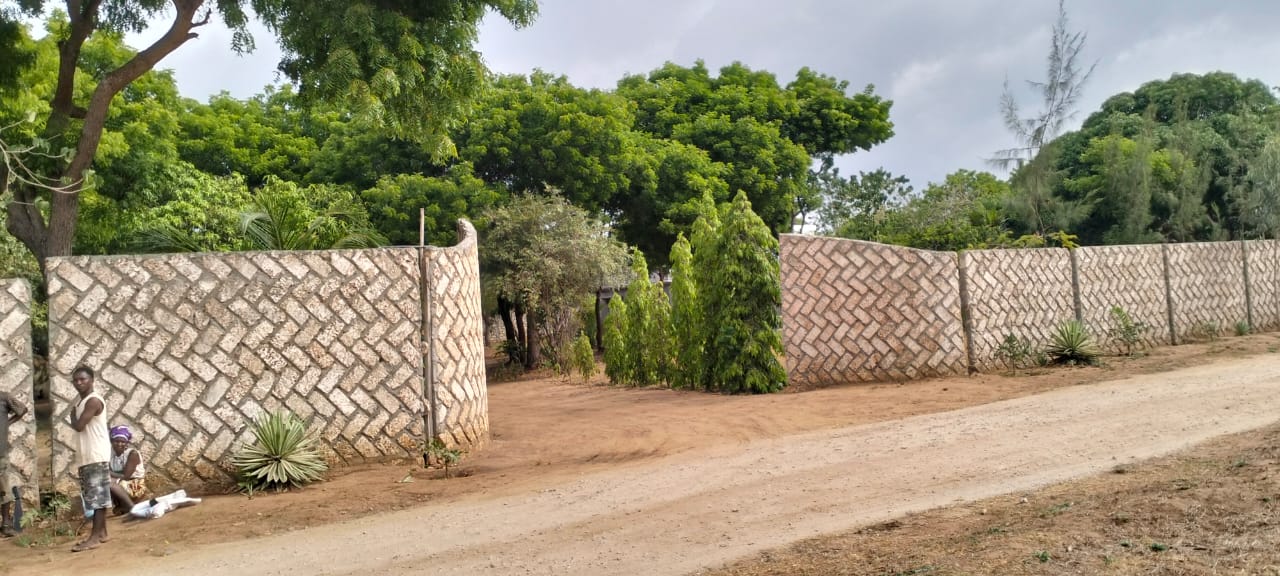 One-acre freehold plots for sale in Kizingo, watamu with red soil, flat land, and on-site utilities.