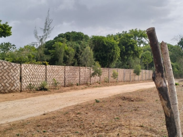 One-acre freehold plots for sale in Kizingo, watamu with red soil, flat land, and on-site utilities.