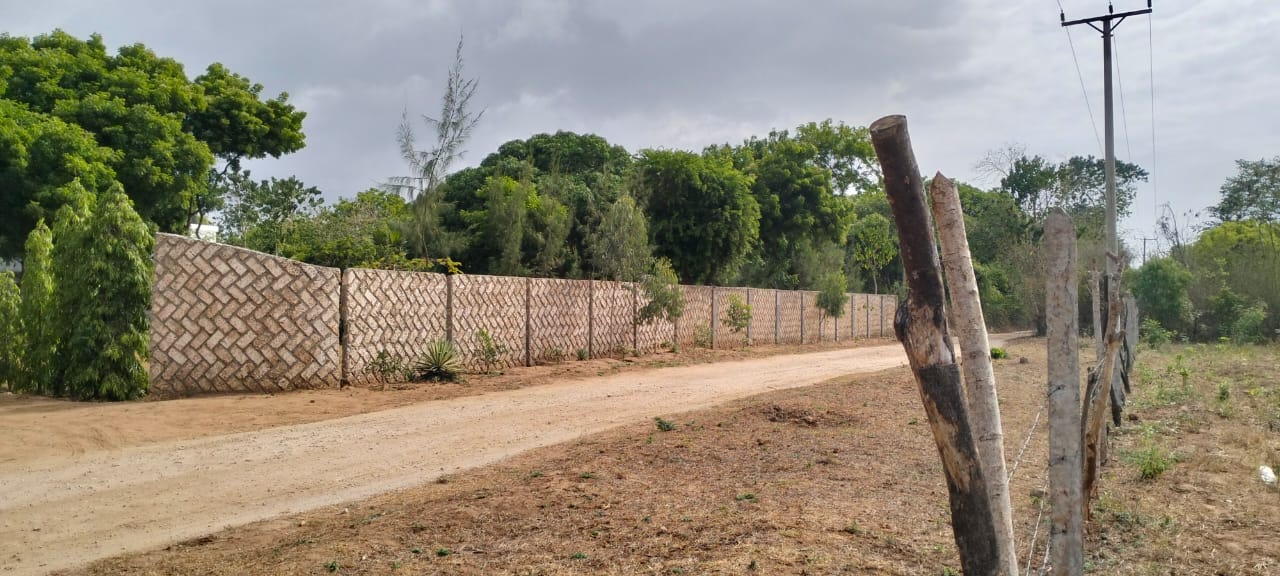 One-acre freehold plots for sale in Kizingo, watamu with red soil, flat land, and on-site utilities.