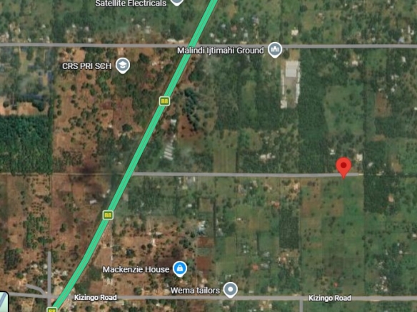 One-acre freehold plots for sale in Kizingo, watamu with red soil, flat land, and on-site utilities.