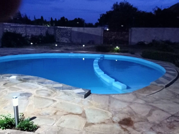 Luxury 4-bedroom furnished villa with private swimming pool for short stays in Casuarina, featuring a walled compound and premium amenities.