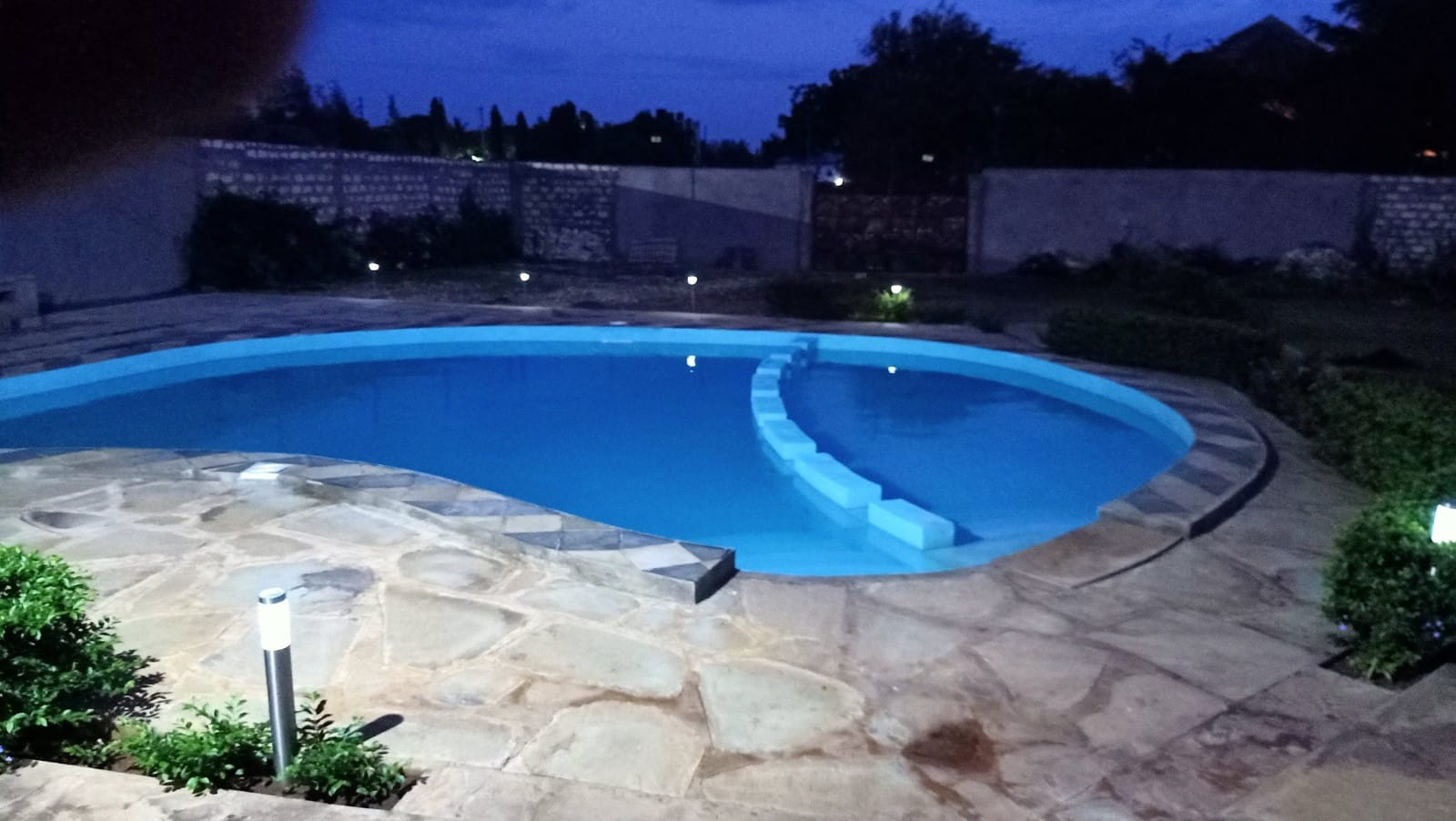 Luxury 4-bedroom furnished villa with private swimming pool for short stays in Casuarina, featuring a walled compound and premium amenities.