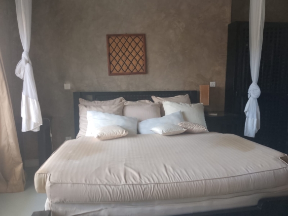 2-bedroom beachfront apartment for rent at Lawfords Malindi with swimming pools, gardens, entertainment facilities, and ocean views.