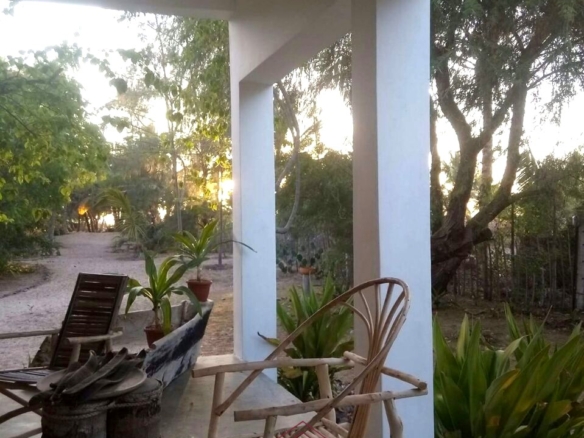 3-bedroom coastal home on 1-acre titled plot in Che Shale with solar panels, rainwater harvesting, balcony, and verandah. Expansion potential on adjoining 3/4-acre land.