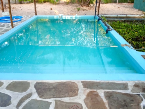 3-bedroom coastal home on 1-acre titled plot in Che Shale with solar panels, rainwater harvesting, balcony, and verandah. Expansion potential on adjoining 3/4-acre land.