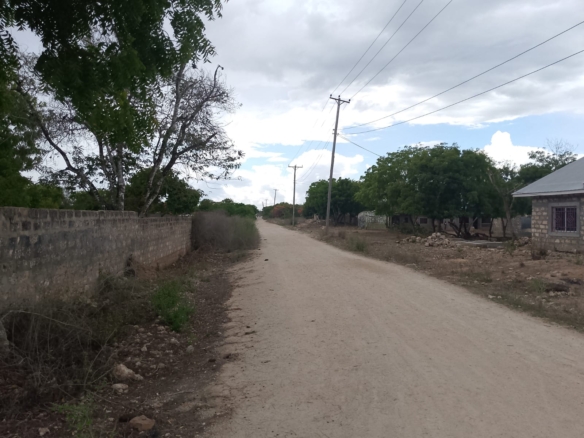 3 acres ocean-view land for sale along Bofa Road near Ngala Beach, featuring road frontage, subdivision potential, and a secure upscale neighborhood.