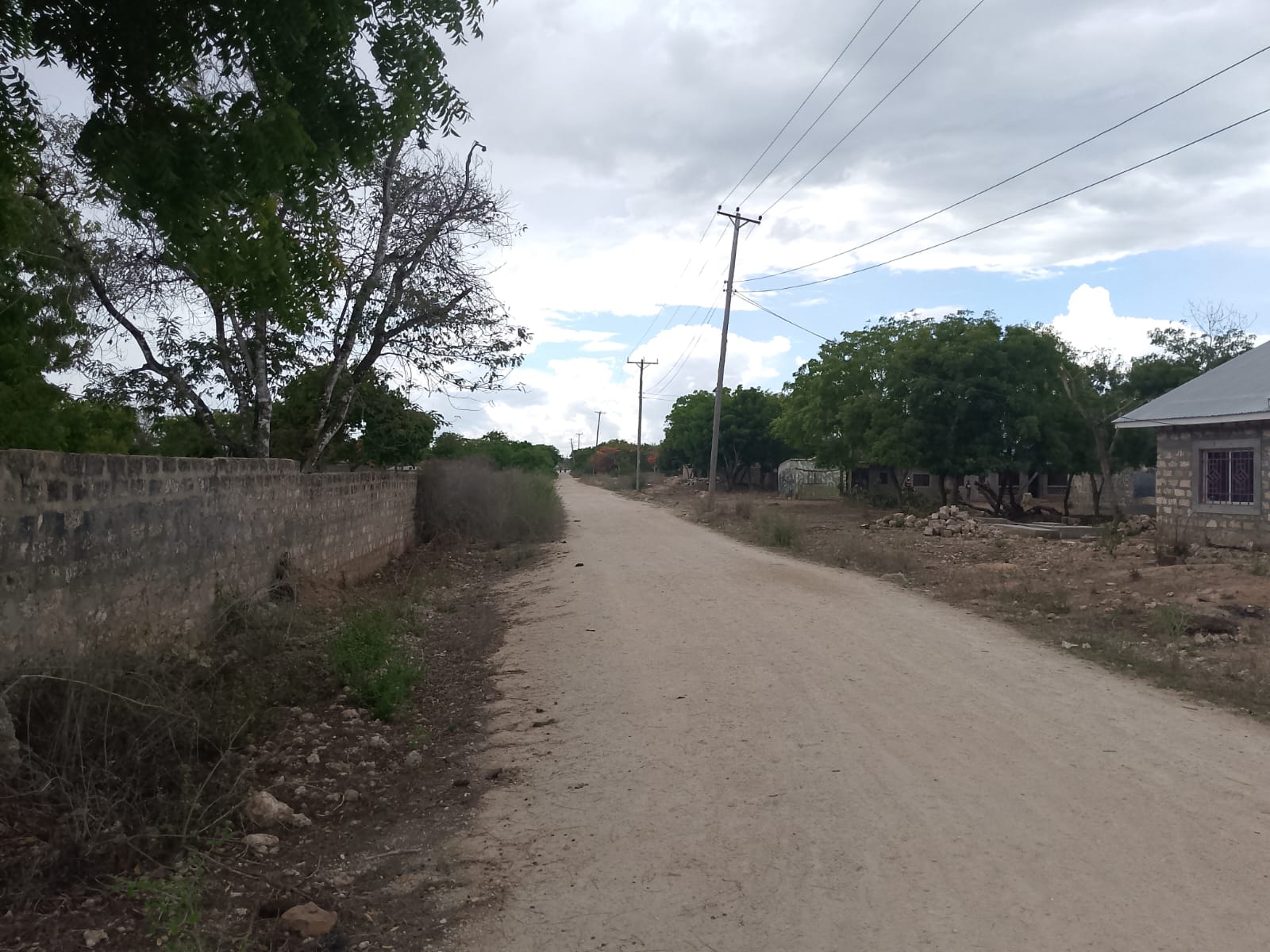 3 acres ocean-view land for sale along Bofa Road near Ngala Beach, featuring road frontage, subdivision potential, and a secure upscale neighborhood.