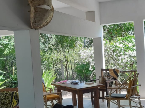 3-bedroom coastal home on 1-acre titled plot in Che Shale with solar panels, rainwater harvesting, balcony, and verandah. Expansion potential on adjoining 3/4-acre land.