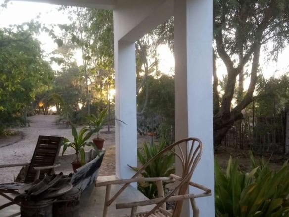 3-bedroom coastal home on 1-acre titled plot in Che Shale with solar panels, rainwater harvesting, balcony, and verandah. Expansion potential on adjoining 3/4-acre land.