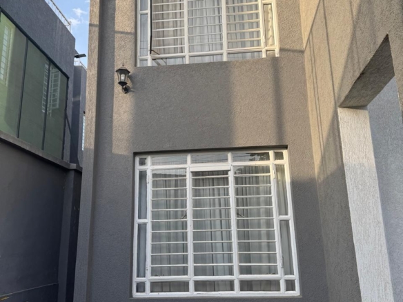 Luxury 4-bedroom house with DSQ for sale in gated community featuring solar panels, modern finishes, and premium amenities.